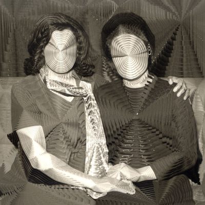 distorted sepia tone portrait image of two women holding hands with circle patterns on their faces and bodies